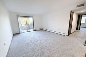 Ft. Mitchell apartment for rent - A spacious room with a carpeted floor and sliding glass doors leading to a balcony.