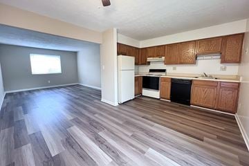 Cincinnati apartment for rent - A kitchen with wooden cabinets and a white refrigerator.