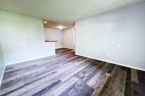 Galloway apartment for rent - the living room and dining room of an apartment with wood flooring at Eagle Crest Apartments, Galloway, OH