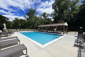 Cincinnati apartment for rent - A pool with a sun lounger and a small building.