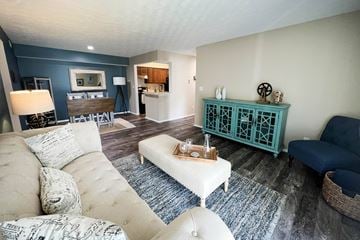 Loveland apartment for rent - a living room with a blue accent wall and a white couch