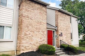 A red door on a brick building