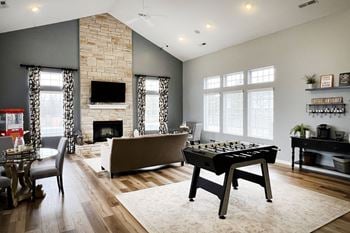 A game room with a foosball table and a couch