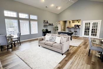 A living room with a couch and a table with chairs