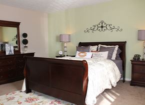 Blue Ash apartment for rent - a bedroom with a bed and a mirror on the wall  at Hunter's Creek Apartments, Cincinnati, OH, 45242