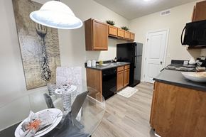 Columbus apartment for rent - an open kitchen and dining room with a glass table and chairs at Residences at Northgate Crossing, Ohio, 43235