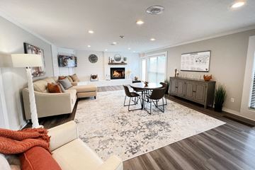 Cincinnati apartment for rent - a living room with couches and a table and a fireplace