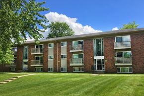 Forest Park apartment for rent - A red brick building with a green lawn in front.