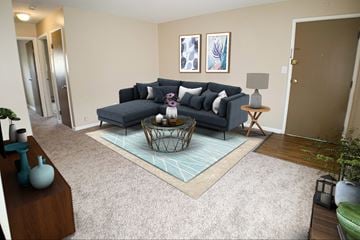 Cincinnati apartment for rent - a living room with a blue couch and a rug