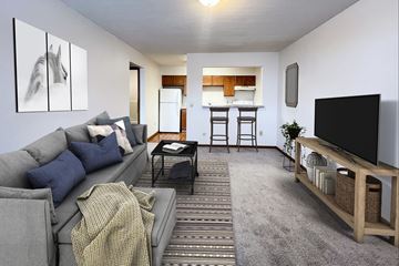 Springfield apartment for rent - A living room with a grey couch and a television on a wooden stand.