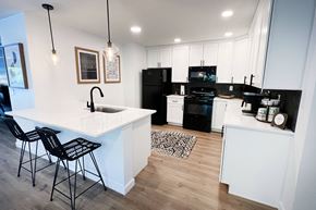 Cincinnati apartment for rent - a kitchen with white cabinets and black appliances at Indian Lookout Apartments, Cincinnati, OH
