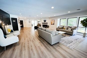 A living room with hardwood floors and white walls