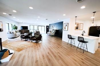 A living room with hardwood floors and white walls