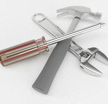 A knife and a hammer are laying on a table
