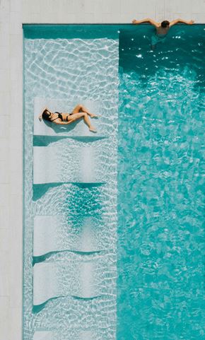 Los Angeles apartment for rent - a woman laying on a towel in a swimming pool