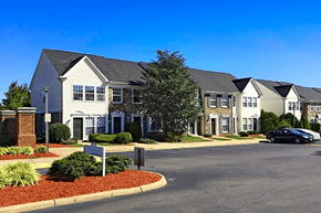 Manassas apartment for rent - a row of houses on a street with a parking lot