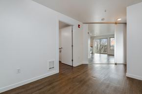 Seattle apartment for rent - a living room and dining room with white walls and wood floors