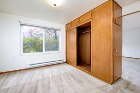 Seattle apartment for rent - a bedroom with a wardrobe and a window