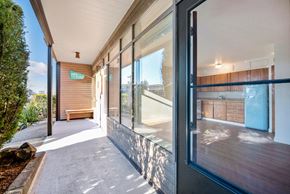 Seattle apartment for rent - the entrance to a building with large glass windows and a walkway