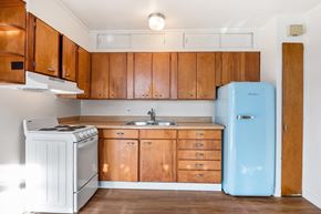 Seattle apartment for rent - an empty kitchen with a stove refrigerator and sink