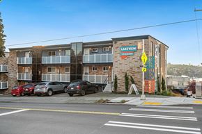 Seattle apartment for rent - an apartment building with cars parked in front of it