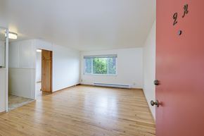 Seattle apartment for rent - a living room with wood floors and a red door