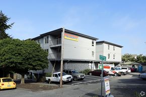 Seattle apartment for rent - the front of a building with cars parked in a parking lot