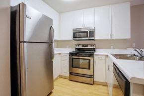 Santa Monica apartment for rent - a kitchen with stainless steel appliances and white cabinets