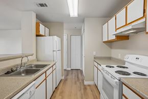 Castle Rock apartment for rent - Pines at Castle Rock 2728 kitchen with white cabinets and a stove top oven.