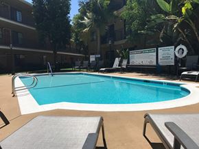 Mission Hills apartment for rent - Woodman Lassen Apartments pool area with lounge chairs