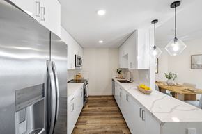 Torrance apartment for rent - a kitchen with white cabinets and stainless steel appliances