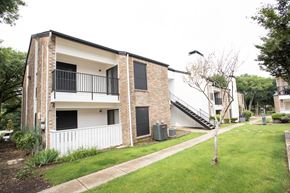 Garland apartment for rent - the exterior of an apartment building with a lawn and a staircase