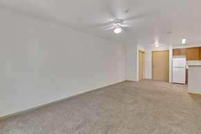 Kent apartment for rent - an empty living room with a kitchen and a ceiling fan