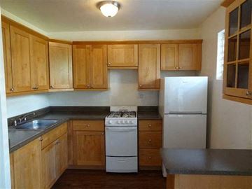 Honolulu apartment for rent - a kitchen with a stove and a refrigerator