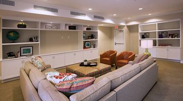 Irvine apartment for rent - a living room with a couch and chairs and a book shelf