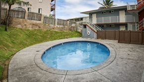 Wailuku apartment for rent - a backyard with a pool and patio with a house in the background