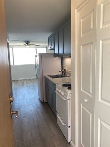 Wailuku apartment for rent - A kitchen with a white stove and a white refrigerator.