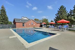 Fort Collins apartment for rent - A red building with a pool in front of it.