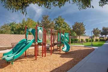Parlier apartment for rent - A playground with a green slide and a red structure.