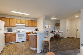 Fort Collins apartment for rent - A kitchen with wooden cabinets and a white fridge.