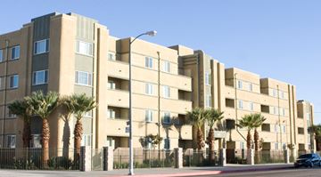 Los Angeles apartment for rent - a large apartment building with palm trees in front of it