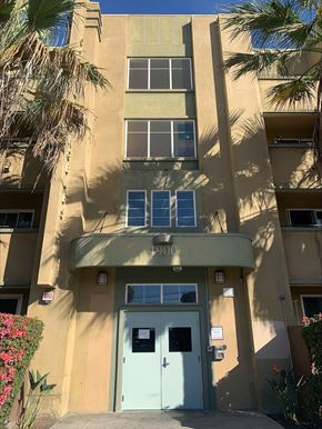Los Angeles apartment for rent - A building with a blue door and windows with shutters.