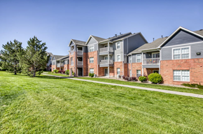 Englewood apartment for rent - A row of modern brick apartment buildings with green lawns in front.