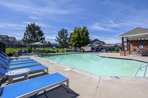 Englewood apartment for rent - A pool area with blue loungers and a clear sky.