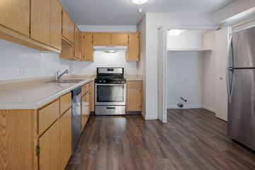 Tracy apartment for rent - A kitchen with wooden cabinets and a stainless steel refrigerator.