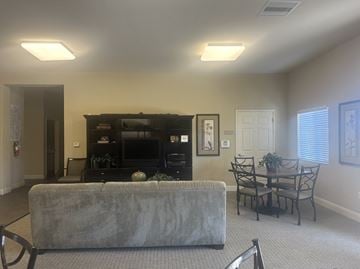 Nipomo apartment for rent - A grey couch is in front of a black television in a living room.