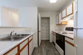 Longmont apartment for rent - A kitchen with white cabinets and a white refrigerator.