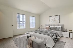 Longmont apartment for rent - A bedroom with a large bed and a window with blinds.