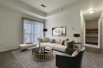 Longmont apartment for rent - A living room with a grey carpet and a white sofa.