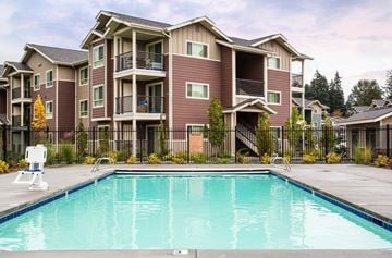 Colorado Springs apartment for rent - A large apartment complex with a pool in front.